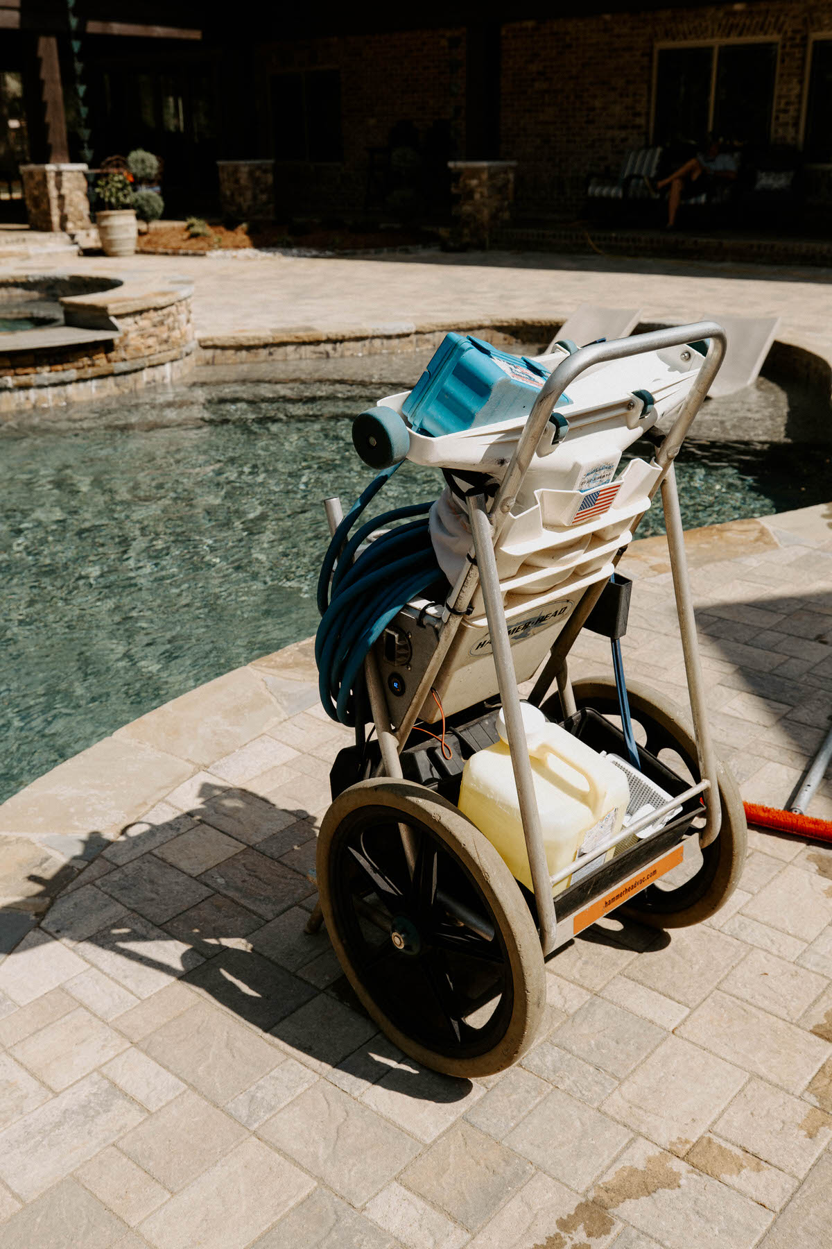 Mid State Pools technician testing pool water chemicals at a Warner Robins backyard pool