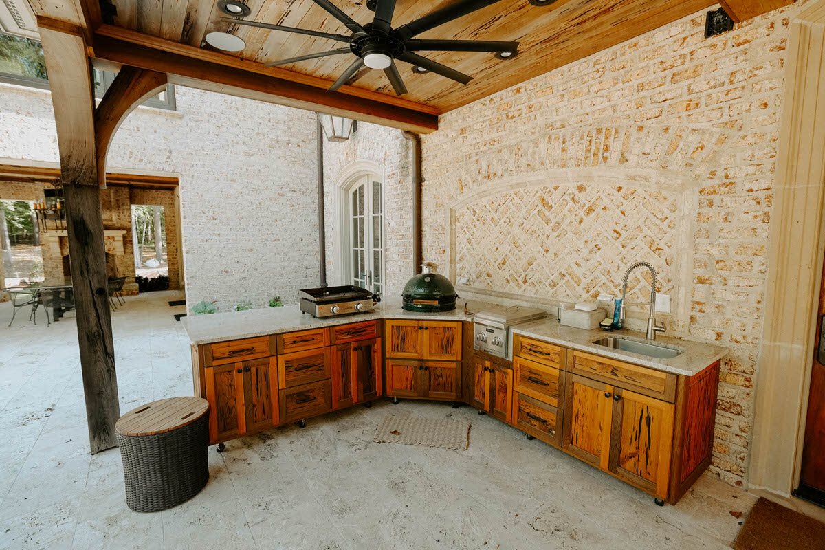 Covered outdoor living and kitchen area beside a pool in Middle Georgia
