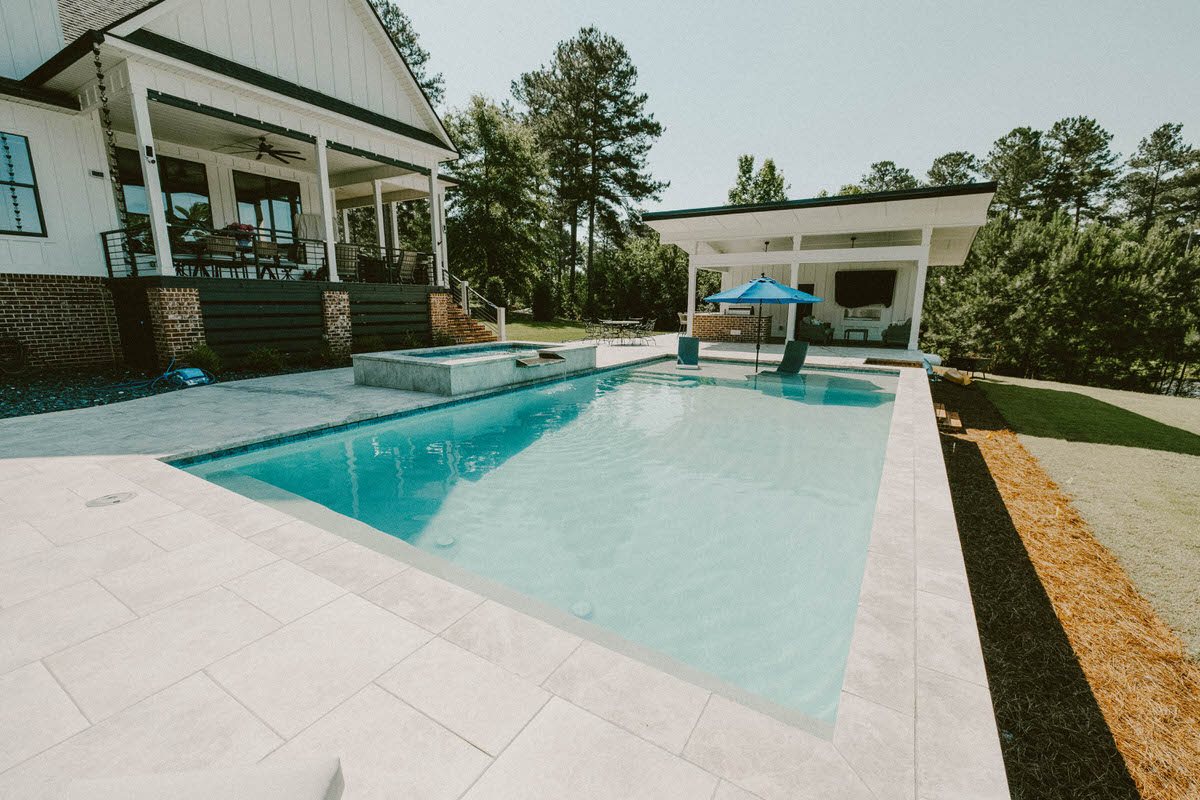 Backyard pool with a covered patio ready for fall swimming at a Warner Robins, Georgia home