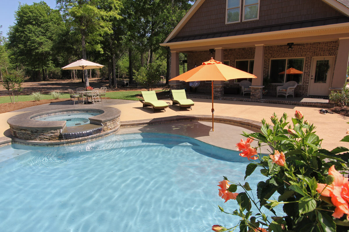 Luxury inground spa with stacked stone surround connected to a custom pool — Mid State Pools Warner Robins GA
