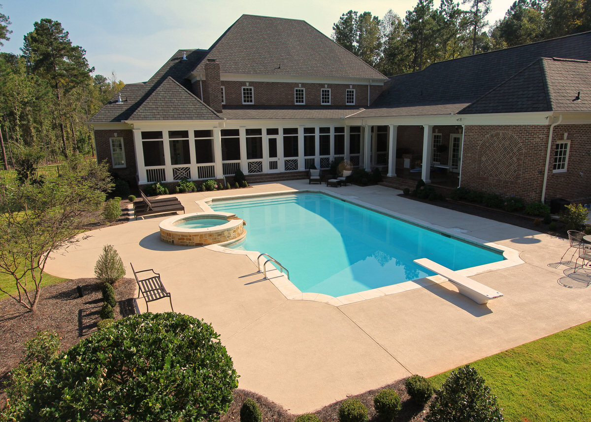 Custom gunite swimming pool installation by Mid State Pools showing completed backyard transformation