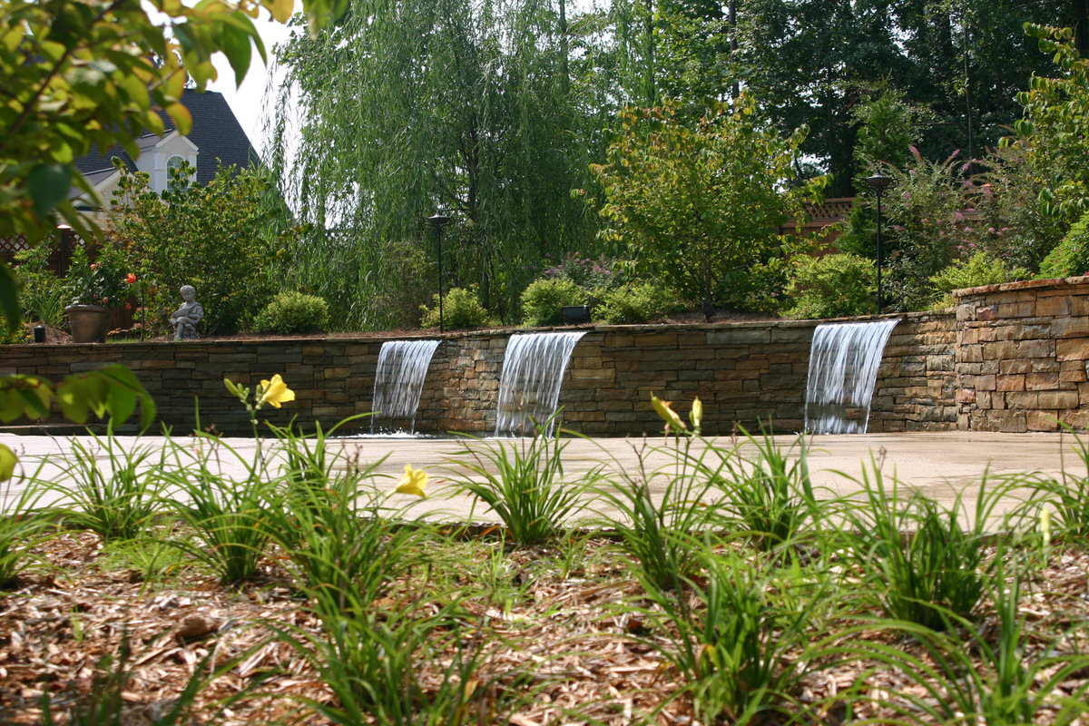 Pool lighting - illuminated swimming pool at night with LED underwater lights and deck lighting creating beautiful ambiance